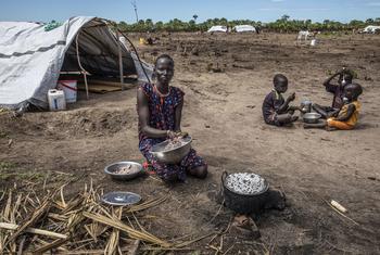 在南苏丹团结州的一处营地，一位母亲正在准备她从粮食计划署那里得到的食物。