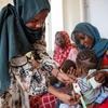 A health worker measures a child for signs of malnutrition in Khartoum, Sudan. Around the world, conflicts and climate-related shocks are driving rising hunger, leaving families struggling to access food, care and stability.