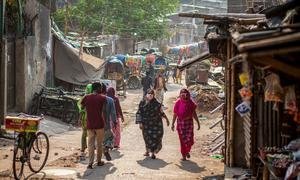 Women wearing the masks while walking in through a market in Dhaka, Bangladesh.