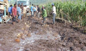 Men work to repair a damaged road in the Mulanje District of Malawi in the aftermath of Cyclone Freddy.