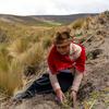 A woman helps restore degraded land in Ecuador.
