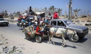 Palestinian families move with their possessions after being told by the Israeli authorities to move to new locations.