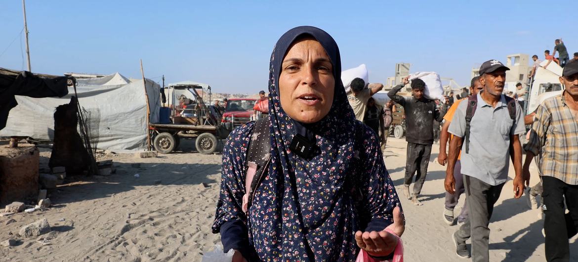 Asma Masoud, a displaced woman from northern Gaza, returning from a search for food. Asma Masoud, a displaced woman from northern Gaza, returning from a search for food.
