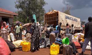 Refugees from Sudan offload their luggage from a truck at a reception centre in northwestern Uganda.