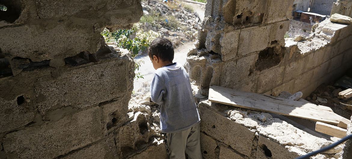 صبي ينظر من منزله المدمر في منطقة الجمالية في تعز، اليمن. (من الأرشيف)