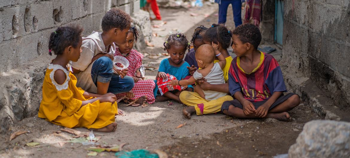 In a neighbourhood in Aden, Yemen, a three-year-old girl (centre) plays with neighbourhood friends after losing her twin sister to measles.