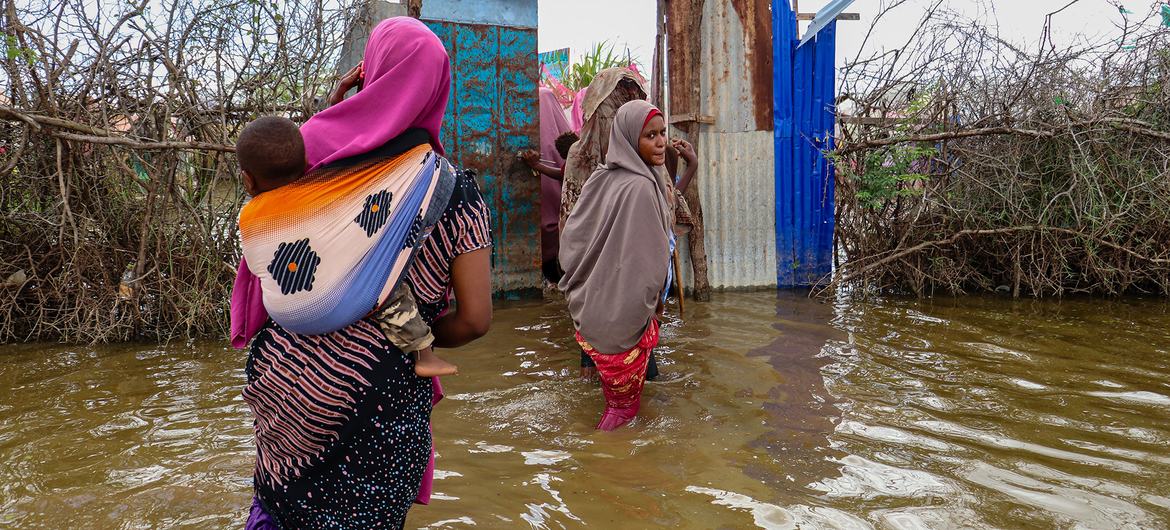 Women wade through flood waters in Jowhar City, Somalia.