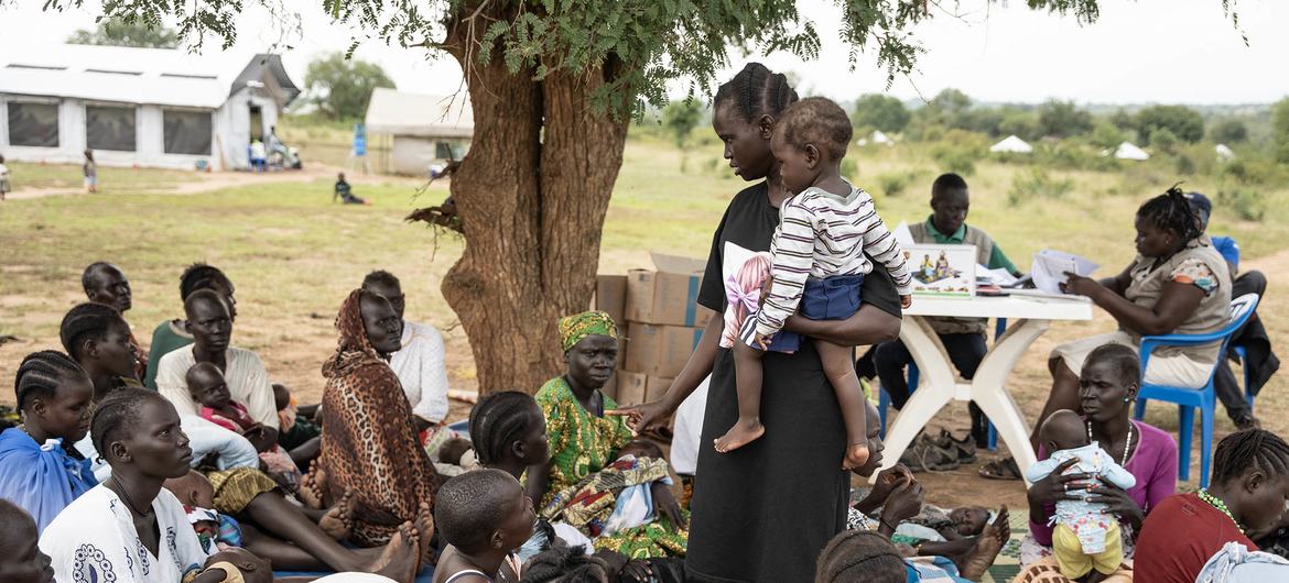 A group of mothers in Uganda discuss the benefits of the UN agency-supported Nutricash project which helps improve nutrition for families in need.