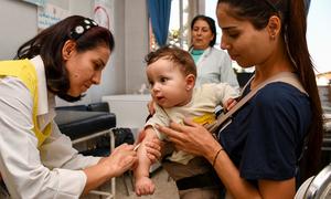 An eight-month-old boy receives his vaccines against polio and measles at a health centre in south Syria.