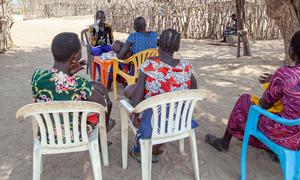 Local community members visit a UN-supported health worker in rural South Sudan, where access to healthcare remains a major challenge.