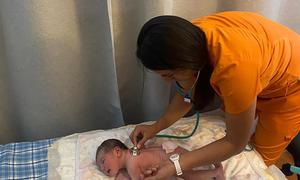 Midwife Silvia Ramos checks the health of a newborn in Mexico.