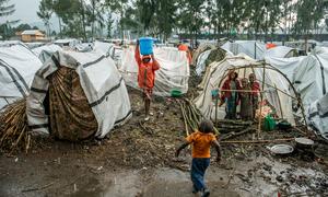 A child carries water through the Kanyaruchinya site for displaced people in eastern Democratic Republic of the Congo...