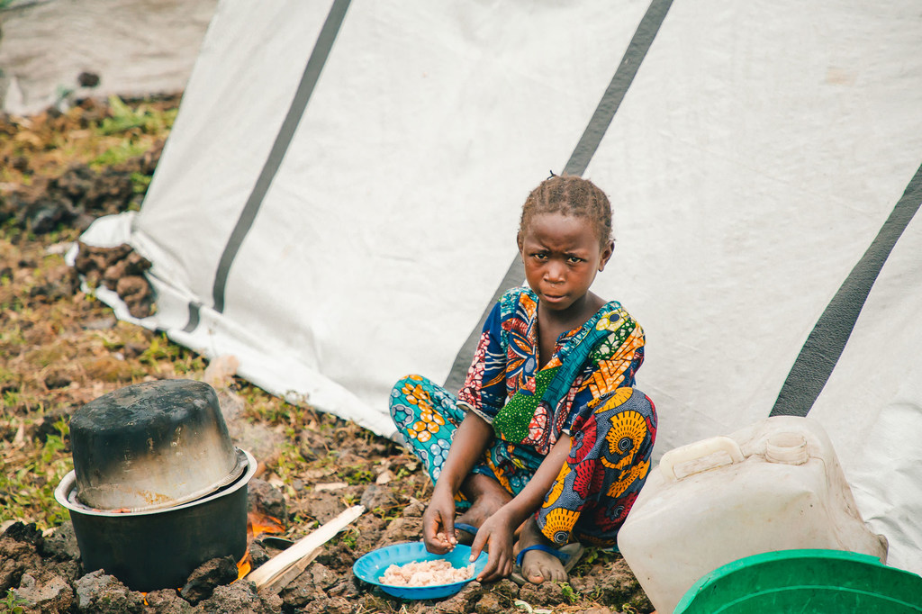 Un jeune enfant mange de la nourriture dans un camp de personnes déplacées dans la province du Nord-Kivu, suite aux combats dans l'est de la République démocratique du Congo.