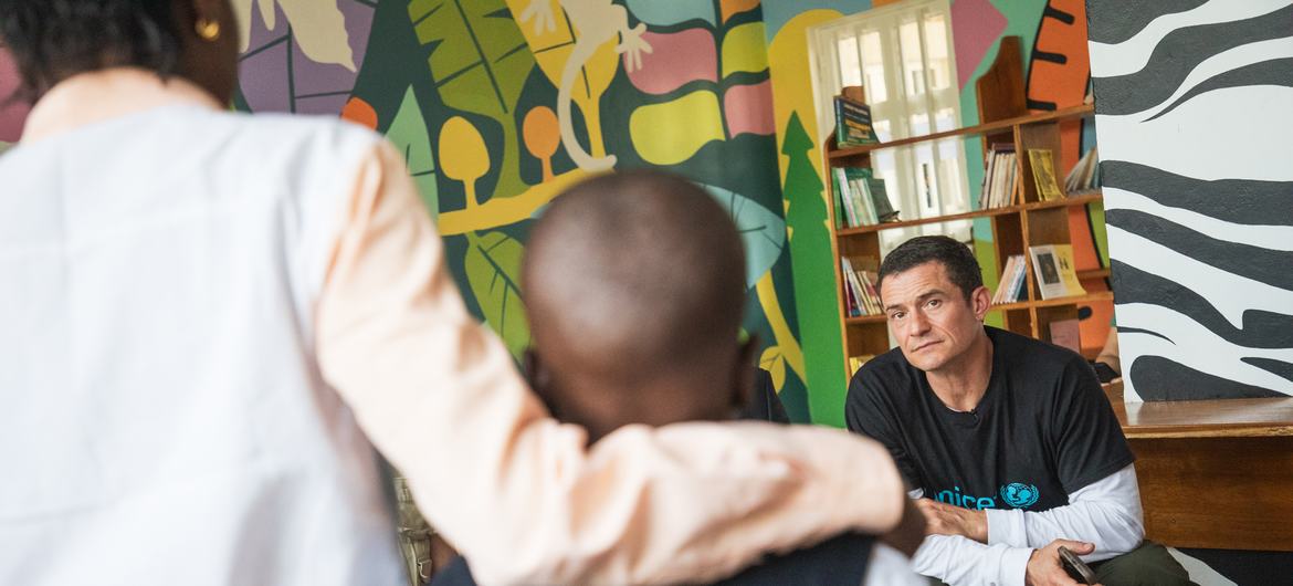 Goodwill Ambassador Orlando Bloom listens to the story of a mother and child while visiting Panzi Hospital in Bukavu, Democratic Republic of the Congo.