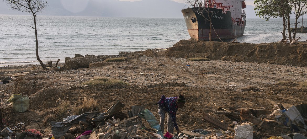 A woman in Indonesia searches through the rubble at a beach in Palu, Indonesia, that was entirely washed away by an October 2018 tsunami. (file)