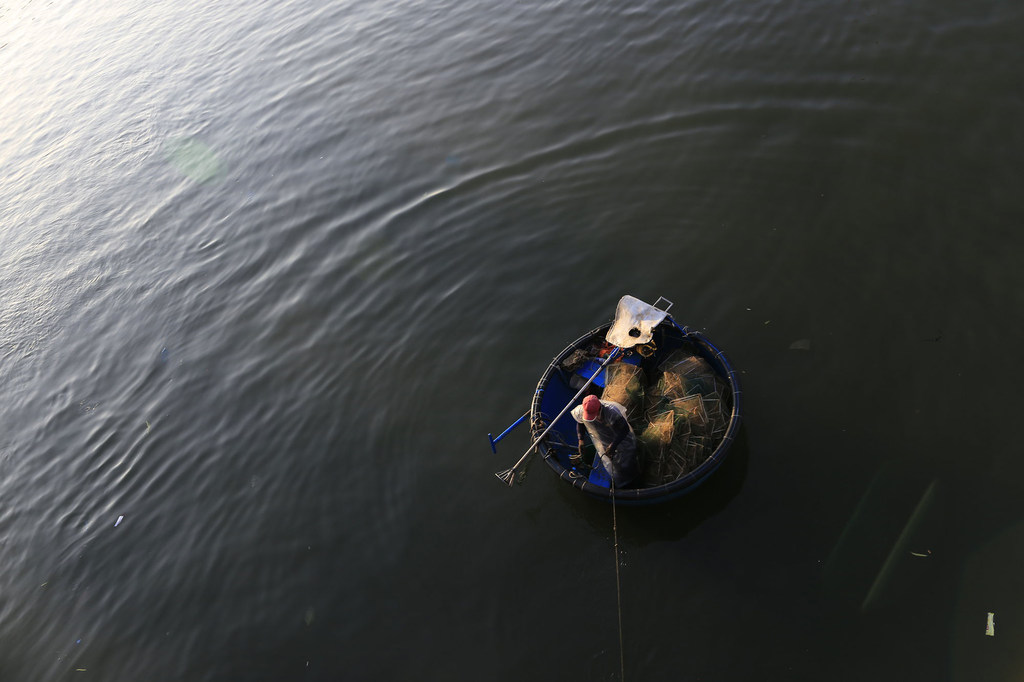 A fisherman works from a small raft off the coast of Viet Nam. Around the world, tens of millions of people rely on precarious livelihoods, often without access to social protection.