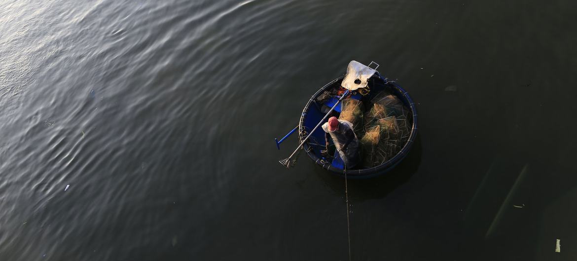 A fisherman works from a small raft off the coast of Viet Nam. Around the world, tens of millions of people rely on precarious livelihoods, often without access to social protection. A fisherman works from a small raft off the coast of Viet Nam. Around the world, tens of millions of people rely on precarious livelihoods, often without access to social protection.