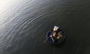A fisherman works from a small raft off the coast of Viet Nam. Around the world, tens of millions of people rely on precarious livelihoods, often without access to social protection.