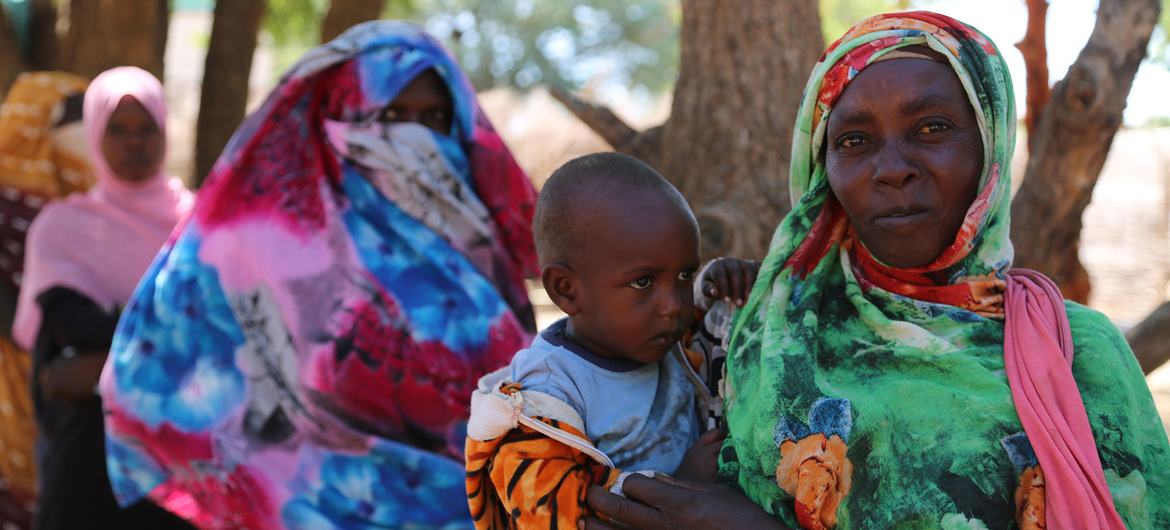 Women line up for WFP distribution of cash assistance at a displaced persons camp in South Darfur, Sudan.