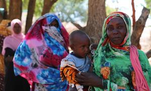 Women line up for WFP distribution of cash assistance at a displaced persons camp in South Darfur, Sudan.