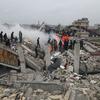 Rescue workers look for survivors in a building  in Samada, Syria destroyed by the February 6 earthquake.