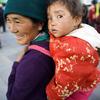A woman carries a child in Barkhor, in the Tibet Autonomous Region. (file)