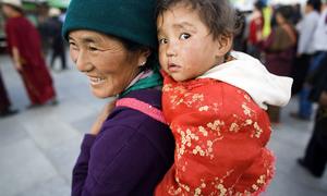 A woman carries a child in Barkhor, in the Tibet Autonomous Region. (file)