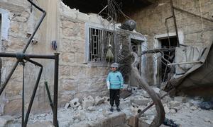 A child stands in the ruins of his family's home, damaged in Syria's devastating 2023 earthquake. (file)