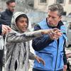 UN relief chief Tom Fletcher talks to a young boy in northern Gaza.