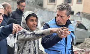 UN relief chief Tom Fletcher talks to a young boy in northern Gaza.