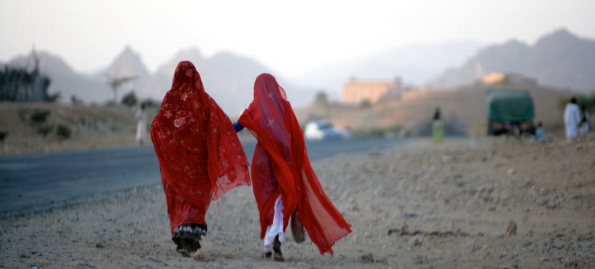 Two women walk along a road outside Keren, a city in the region of Anseba in Eritrea.