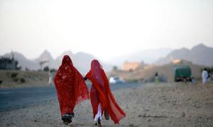 Two women walk along a road outside Keren, a city in the region of Anseba in Eritrea.