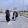 Abdullah e Aisha Qarmout caminhando pela rua Al Rachid no caminho do norte de Gaza para o sul