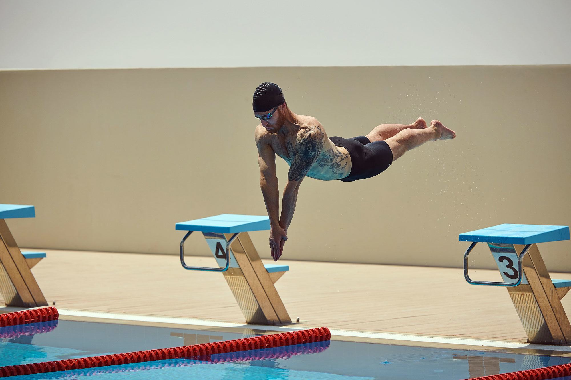 US paralympian Brad Snyder dives into a swimming pool during a competition.