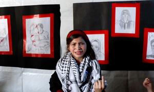 Fatima Al-Za'anin, a displaced Palestinian girl from Beit Hanoun (Gaza), speaks about her drawings in an art exhibition organized by UNRWA in Gaza City as part of its mental health and psychosocial support services.