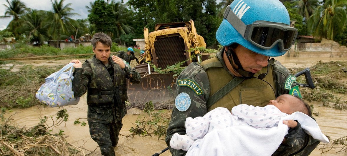A UN peacekeeper rescues a child after parts of the capital of Haiti, Port-au-Prince were flooded during a tropical storm in 2007. A UN peacekeeper rescues a child after parts of the capital of Haiti, Port-au-Prince were flooded during a tropical storm in 2007.