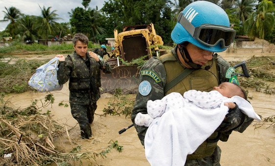 A UN peacekeeper rescues a child after parts of the capital of Haiti, Port-au-Prince were flooded during a tropical storm in 2007.