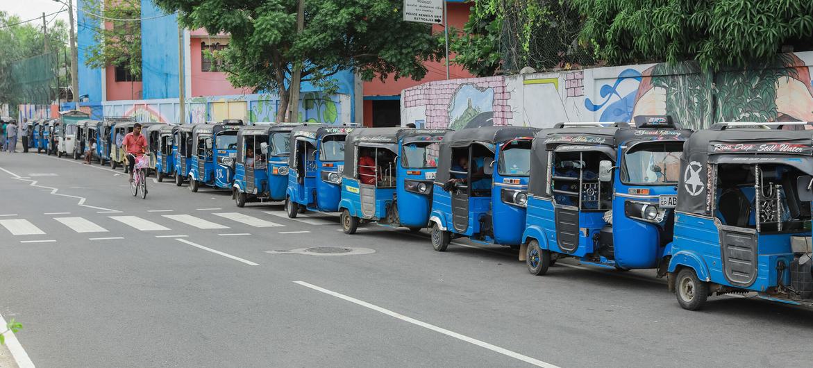 In July 2022, autorickshaws wait in a long queue at a Sri Lankan fuel station, amidst a severe economic crisis.