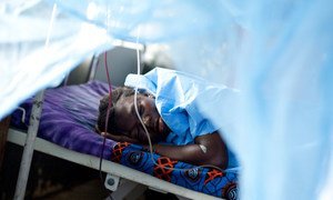 A woman whose baby was stillborn after a 10-hour labour sleeps in the maternity ward of a hospital in Sierra Leone.