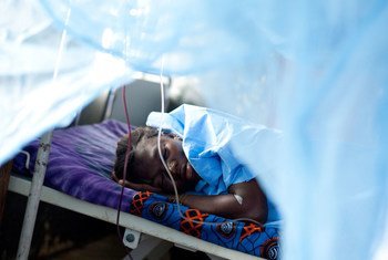 A woman whose baby was stillborn after a 10-hour labour sleeps in the maternity ward of a hospital in Sierra Leone.