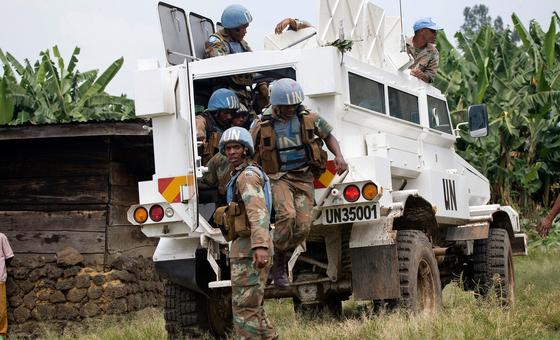 Members of the MONUC’s South African parachute battalion disembark from a military vehicle for patrol duties around the village of Ntamugenga.