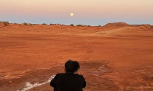 Asmaa Niang looks across an arid desert.
