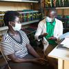 Un infirmier reçoit une patiente séropositive dans un centre de santé à Namayingo, en Ouganda.