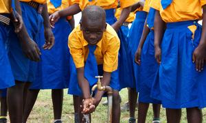 Children wash their hands at a water system installed at their primary school in north eastern Uganda.