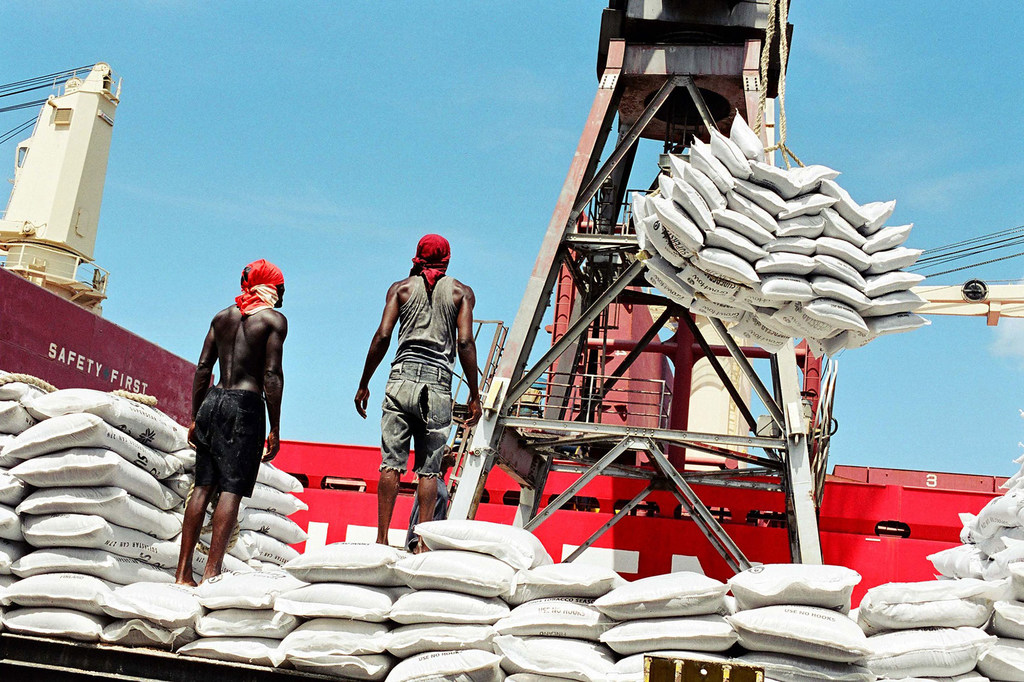Dock workers unload cargo from a ship in Dar es Salaam, Tanzania.
