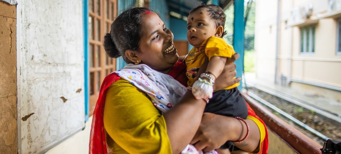 A mother with her child at the vaccine center. A mother with her child at the vaccine center.