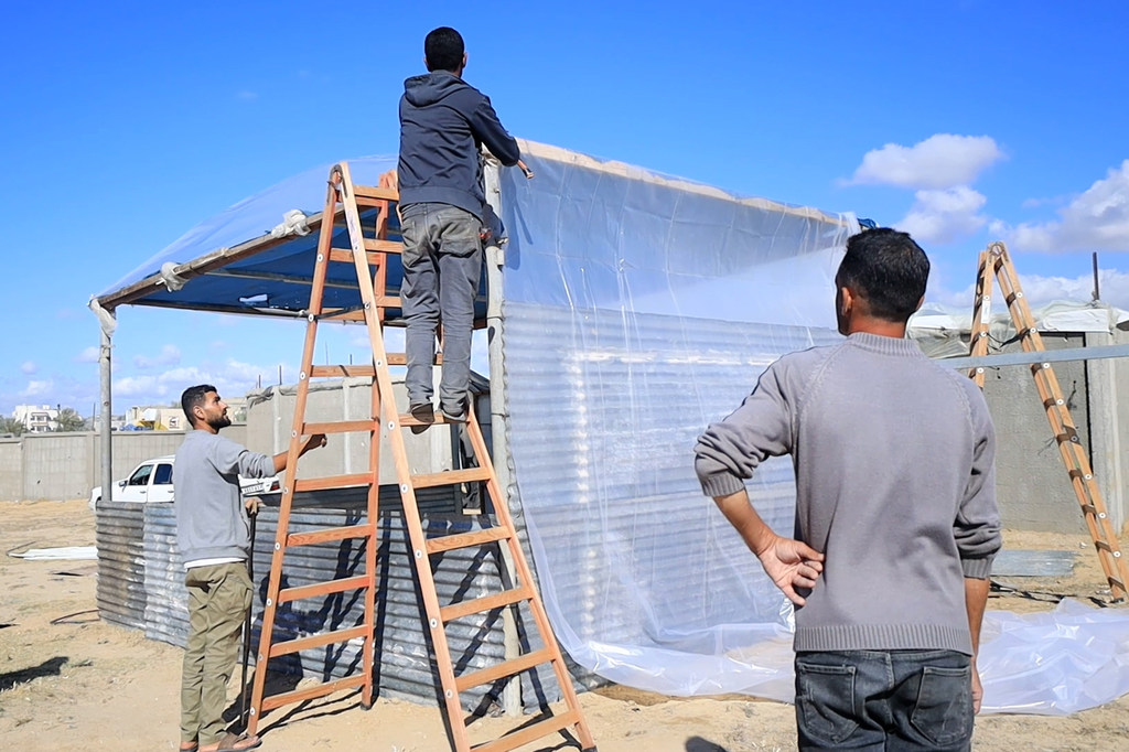 Un groupe de personnes déplacées construit de nouvelles tentes à Al Mawasi, dans le centre de Gaza.