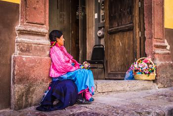 一名土著妇女在墨西哥圣地亚哥德奎拉塔罗的街道上卖娃娃。