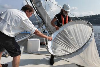 Jean-Yves Carval (left), captain of the Sagitta III, and his chief mechanic, Christophe Kieger, fish zooplankton with a special net.