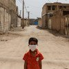 A boy stands in a disadvantaged neighbourhood of Ahvaz, Iran.